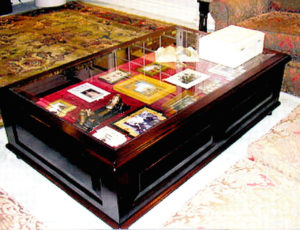 #105 Coffee Table made of Mahogany with raised panels on three sides.  Two drawers with lock and key.  The drawers are lined with velvet and there is a beveled glass top. Finish:  Red mahogany stain and semi-gloss lacquer. 60" x 36"x 18"