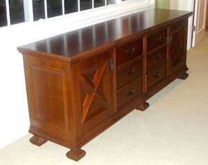 #444  Maple Dresser This beautiful dresser features 6 drawers and two doors with  hand crafted panels and feet.  The dresser is a wonderful piece on it’s own and every more so when paired with our #441 bed. The finish is a medium brown stain and satin lacquer.